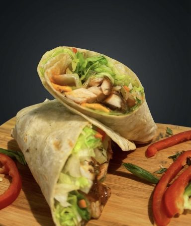 Combo 10: Jerk Fish Wrap Meal: Delicious jerk Fish wrap served with chips and choice of can drink.
